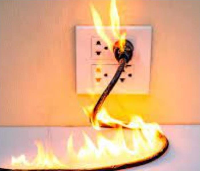 Fire coming out of an outlet due to an electrical fire